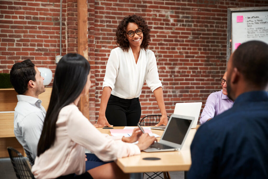 businesswoman-standing-and-leading-office-meeting-VDNP63K.jpg