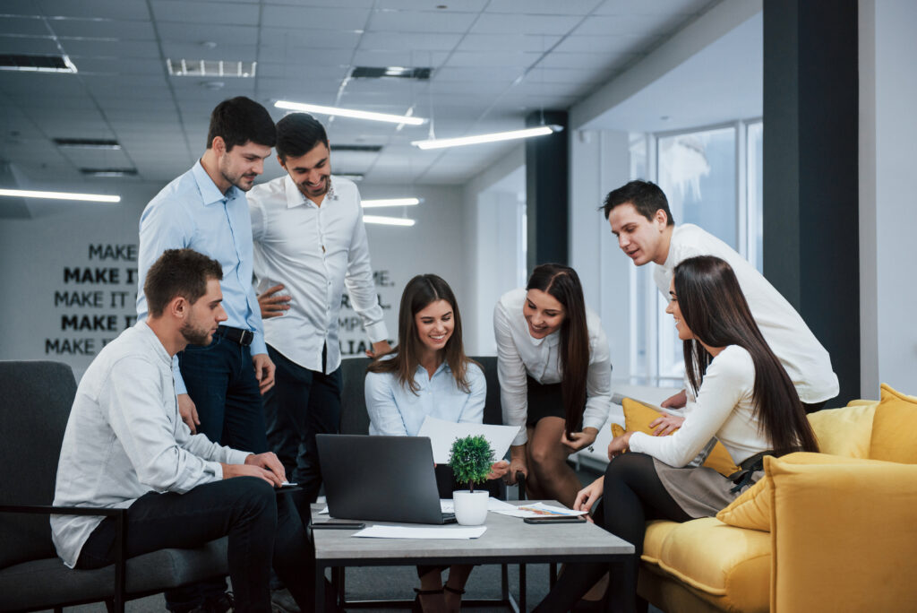 Into success. Group of young freelancers in the office have conversation and smiling.