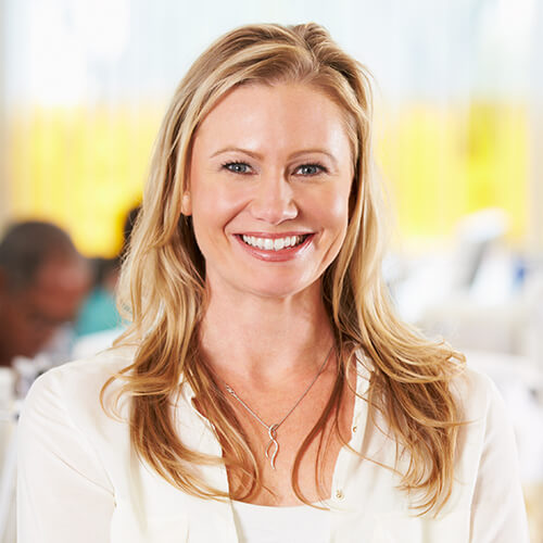 portrait-of-woman-standing-in-busy-creative-office-P2F47DX.jpg